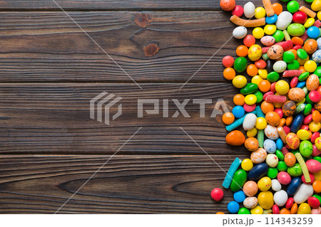 Mixed collection of colorful candy, on colored background. Flat lay, top view. frame of colorful chocolate coated candy Mixed collection of colorful candy, on colored background. Flat lay, top view. frame of colorful chocolate coated candy 114343259