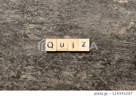 Quiz word written on wood block. Quiz text on cement table for your desing, Top view concept 114343287
