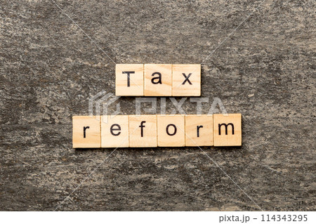 tax reform word written on wood block. tax reform text on cement table for your desing, concept tax reform word written on wood block. tax reform text on cement table for your desing, concept 114343295