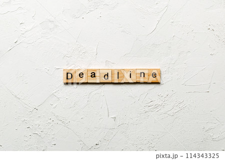 DEADLINE word written on wood block. DEADLINE text on cement table for your desing, concept DEADLINE word written on wood block. DEADLINE text on cement table for your desing, concept 114343325