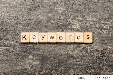 KEYWORDS word written on wood block. KEYWORDS text on cement table for your desing, concept KEYWORDS word written on wood block. KEYWORDS text on cement table for your desing, concept 114343387