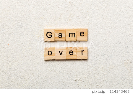 game over word written on wood block. game over text on table, concept 114343465