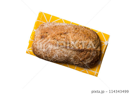 Freshly baked delicious french bread with napkin isolated on white background top view. Healthy white bread loaf 114343499