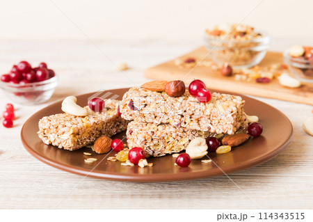Various granola bars on table background. Cereal granola bars. Superfood breakfast bars with oats, nuts and berries, close up. Superfood concept 114343515