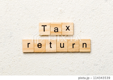 tax return word written on wood block. tax return text on cement table for your desing, concept 114343539