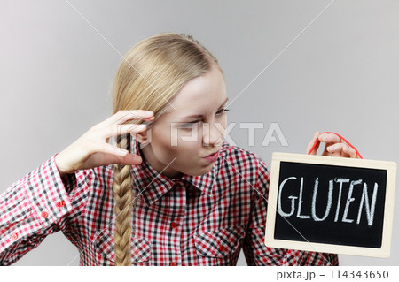 Angry woman holding board with gluten sign 114343650
