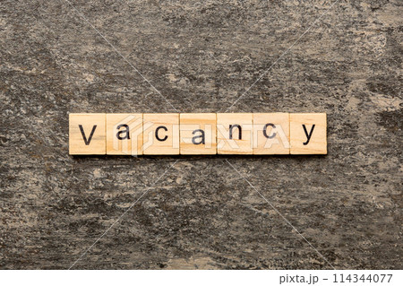 Vacancy word written on wood block. Vacancy text on cement table for your desing, concept 114344077