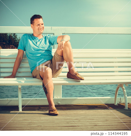 Handsome man tourist on pier. Fashion summer. 114344195