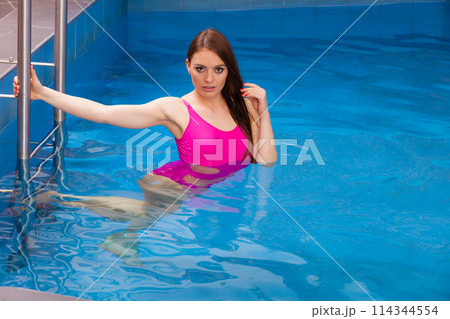 Woman having fun in swimming pool 114344554