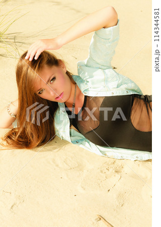 adorable girl lying on sandy beach adorable girl lying on sandy beach 114344581