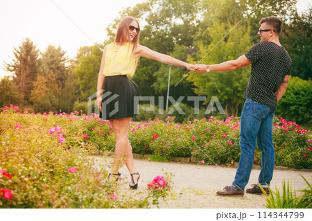 Happy couple around flowers Happy couple around flowers 114344799