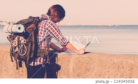 Man hiker with backpack tramping by seaside 114345038