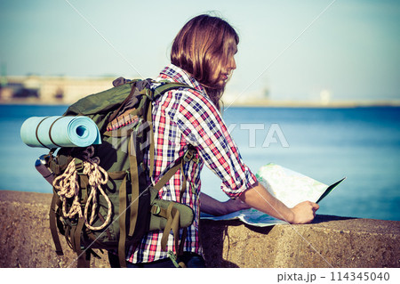 Man hiker with backpack tramping by seaside 114345040