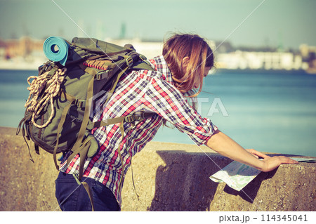 Man hiker with backpack tramping by seaside 114345041