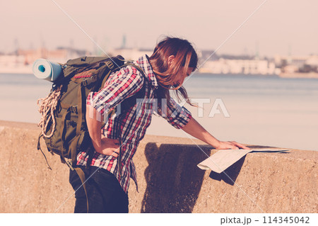 Man hiker with backpack tramping by seaside 114345042
