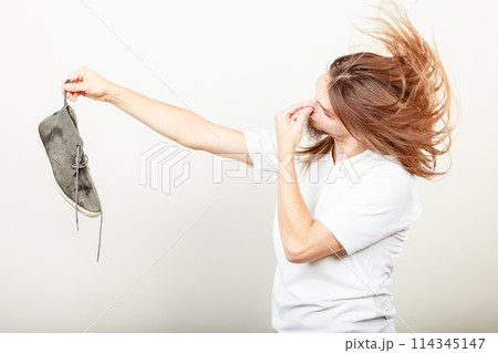 Man with stinky shoe 114345147