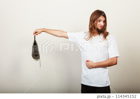 Man with stinky shoe 114345152