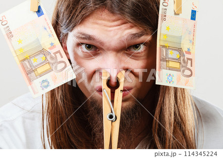 Young man sick of money 114345224