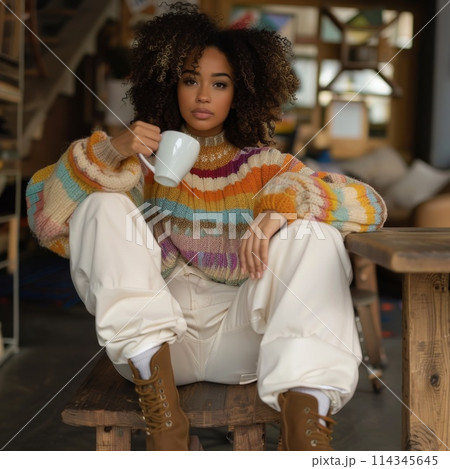 Stylish Woman in Colorful Sweater Enjoying Coffee in Cozy Interior 114345645