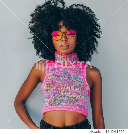Stylish Young Woman Wearing Colorful Knit Sweater and Pink Sunglasses 114345652
