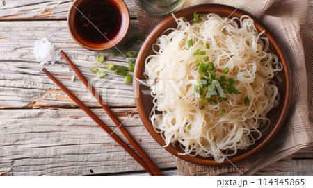 Japanese shirataki noodles with spring onions and soy sauce on a plate. Japanese shirataki noodles with spring onions and soy sauce on a plate. 114345865