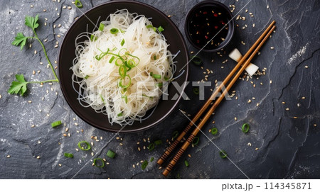 Shirataki noodles with chopped green onions in bowl on black background 114345871