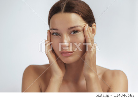 Anti Aging Treatment and Facelift Skin Care Concept. Woman with hand on cheek and eye Anti Aging Treatment and Facelift Skin Care Concept. Woman with hand on cheek and eye 114346565