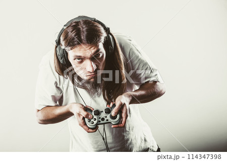 Male player focus on play games 114347398