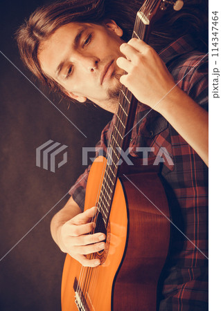 Focused hippie with his guitar. Focused hippie with his guitar. 114347464