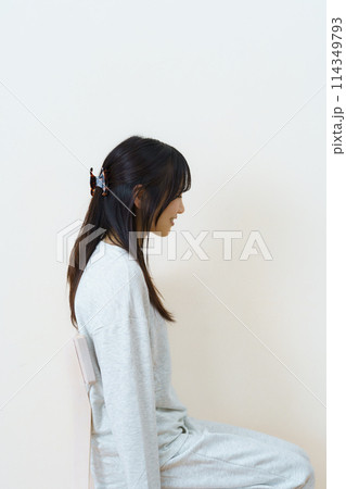 椅子に座って運動をする若い女性 114349793