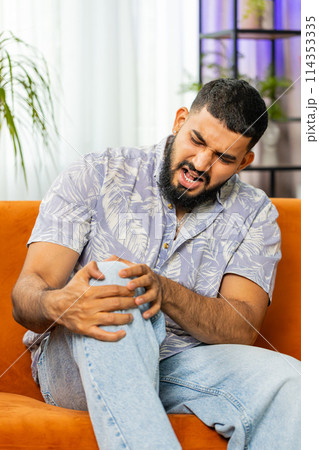 Indian Arabian man suffer from painful severe knee joint ache, leg muscles illness cramps rheumatism Indian Arabian man suffer from painful severe knee joint ache, leg muscles illness cramps rheumatism 114353335