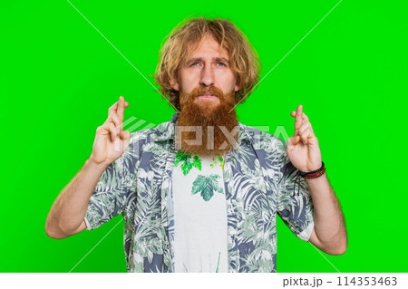 Man crossed fingers looking at camera ask for good luck news, wishing good exam results, play game Man crossed fingers looking at camera ask for good luck news, wishing good exam results, play game 114353463