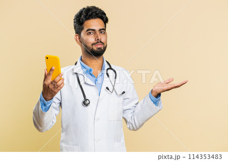 Doctor man using smartphone show point empty place, advertising application area, positive feedback Doctor man using smartphone show point empty place, advertising application area, positive feedback 114353483