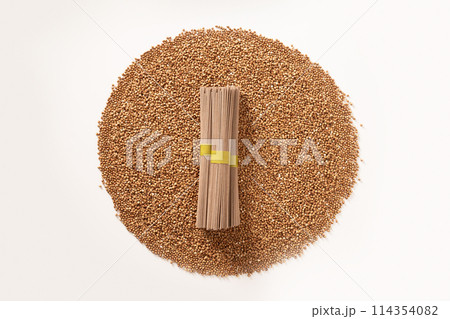 Raw buckwheat noodles soba in bundle on white background. Healthy vegan diet. Alternative gluten free pasta. Organic food. Raw buckwheat noodles soba in bundle on white background. Healthy vegan diet. Alternative gluten free pasta. Organic food. 114354082