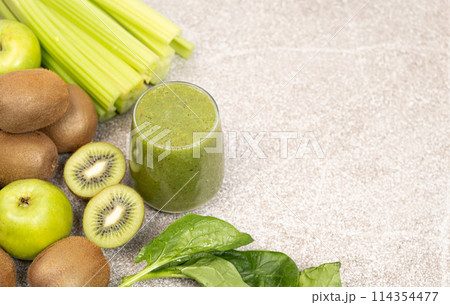 Green smoothie with kiwi, apples, celery, spinach, a healthy natural foods dish, copy space for text 114354477