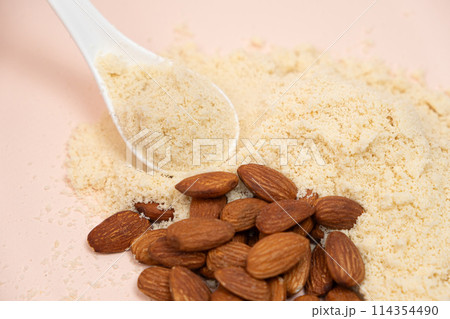 Almond flour and almonds on a beige background Almond flour and almonds on a beige background 114354490