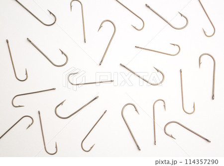Many fishing hooks on a white paper background 114357290