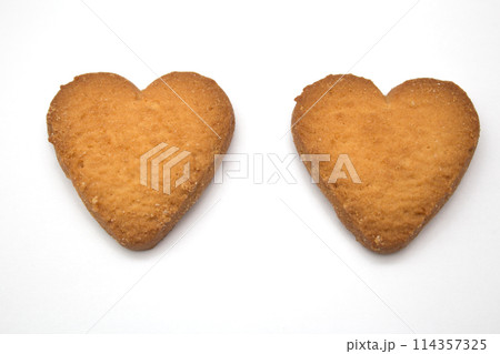 Two cookies in the form of hearts - symbol of love Two cookies in the form of hearts - symbol of love 114357325