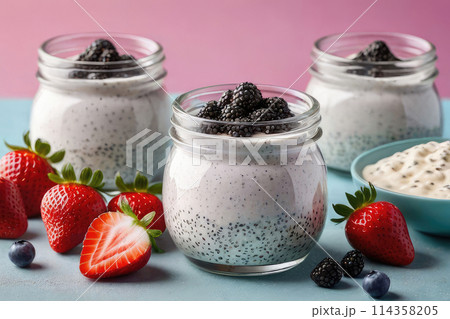 Delicious chia pudding yogurt with strawberry sauce and strawberry in glass jar on a pastel background, summer dessert. Delicious chia pudding yogurt with strawberry sauce and strawberry in glass jar on a pastel background, summer dessert. 114358205