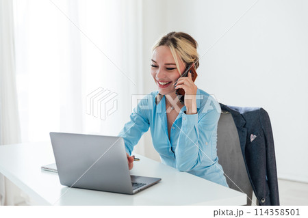 Business woman conducting negotiations online on phone and laptop Business woman conducting negotiations online on phone and laptop 114358501