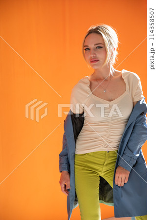 Beautiful fashionable woman in autumn raincoat 114358507
