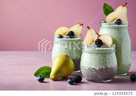 Delicious chia pudding yogurt with pear sauce and pear in glass jar on a pastel background, summer dessert. 114358573