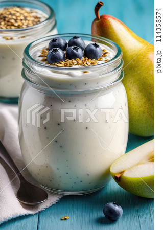Delicious chia pudding yogurt with pear sauce and pear in glass jar on a pastel background, summer dessert. 114358574