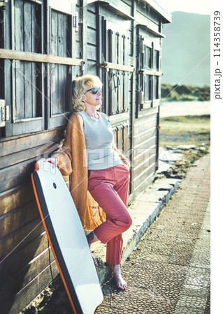 Young mature blonde woman outdoor with a bodyboard. Young mature blonde woman outdoor with a bodyboard. 114358739