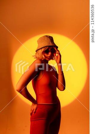 Fashionable portrait of blonde lady in sunglasses posing.  114360536