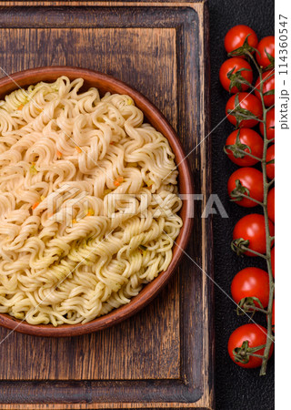 Delicious Asian dish rice noodles or udon with vegetables, spices and herbs 114360547