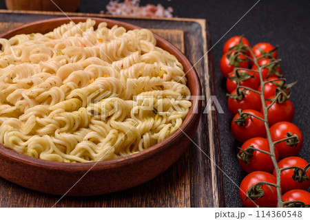 Delicious Asian dish rice noodles or udon with vegetables, spices and herbs Delicious Asian dish rice noodles or udon with vegetables, spices and herbs 114360548