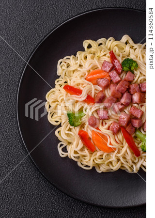 Delicious Asian dish rice noodles or udon with vegetables, spices and herbs Delicious Asian dish rice noodles or udon with vegetables, spices and herbs 114360584