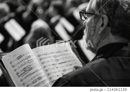 musician looking at notes in choir 114361130