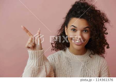 Happy female showing number one with her finger. Woman pointing finger up 114361376